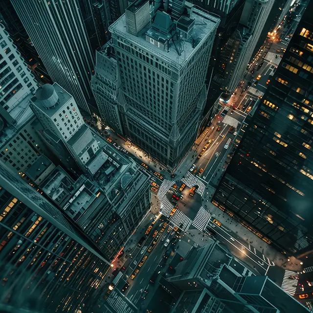 A bustling cityscape at night with illuminated buildings, symbolising opportunities for new chauffeurs to work in vibrant urban environments