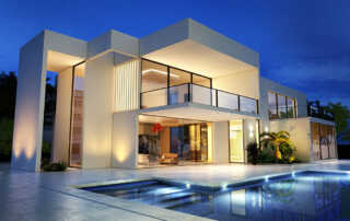 Modern luxury villa with pool at night, ideal for high-end real estate viewings